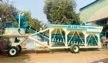 A Nilkanth NE-60-SP stationary concrete batching plant with a pan mixer, successfully installed and operating for construction projects in Vagra, Bharuch, Gujarat.