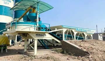 A heavy-duty Nilkanth NE-60-SP stationary concrete batching plant featuring a 100-ton cement silo, installed for major infrastructure work in Dwarka, Gujarat.